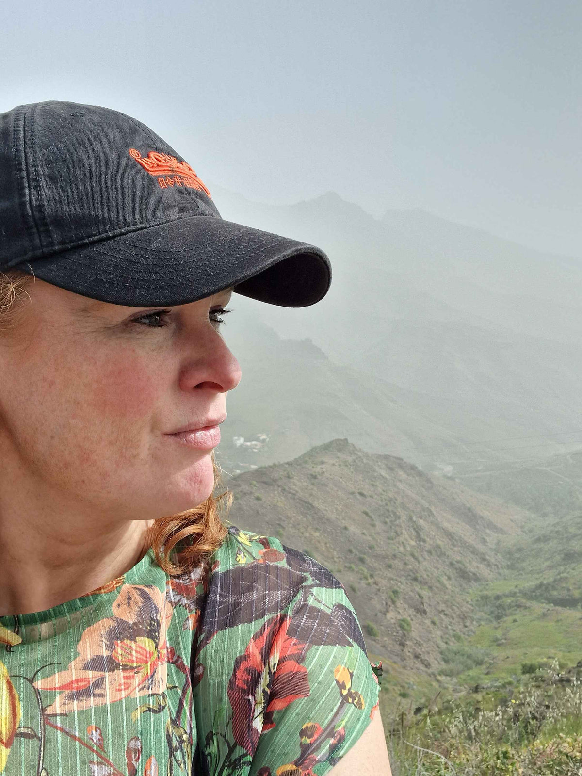 lady in a cap with misty mountains in the background. leadership development coaching in norwich norfolk peak performance hr
