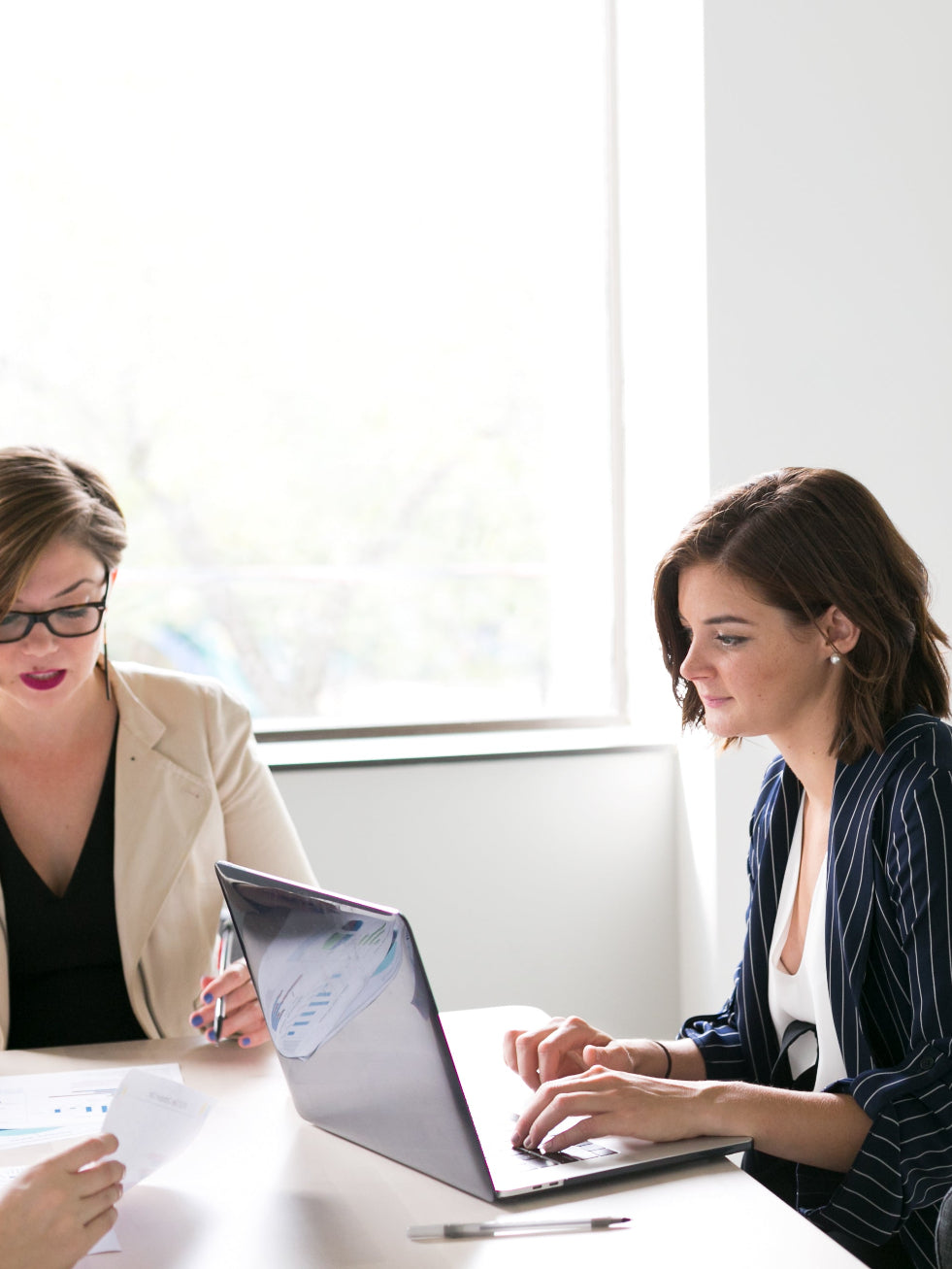 two women sat in a white office working. networking skills coaching in Norwich Norfolk peak performance hr