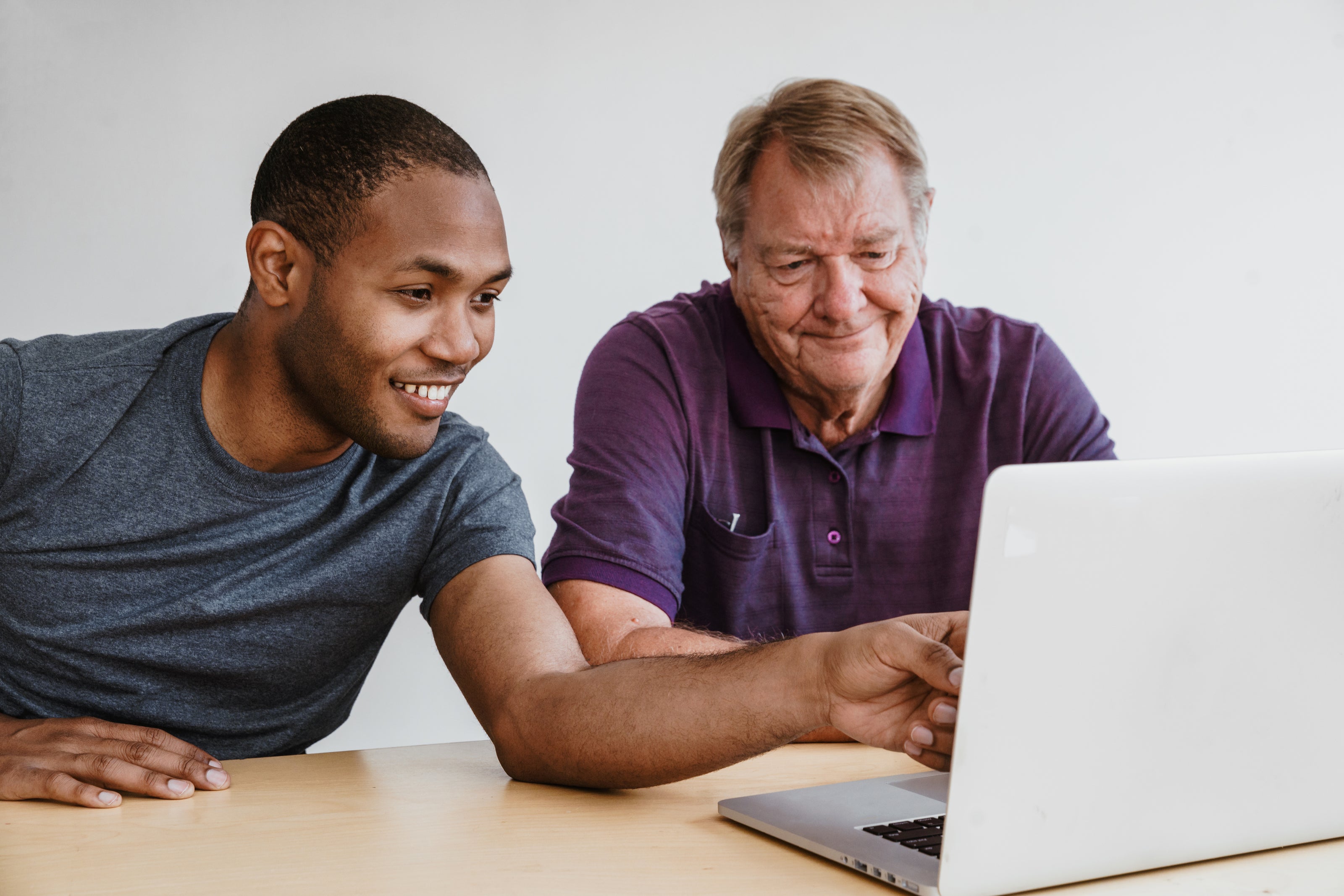 two men young and old looking at a laptop screen workplace resilience workshop Norwich Norfolk peak performance hr
