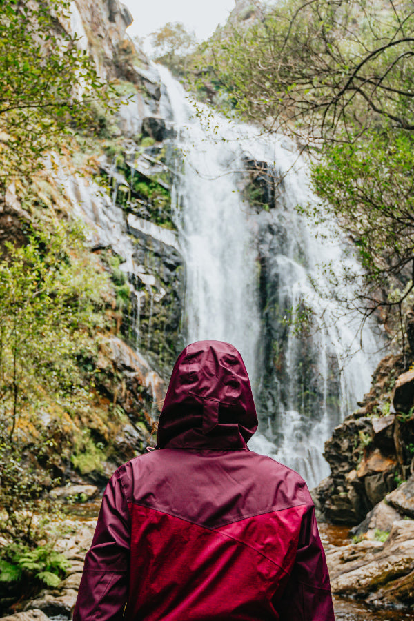 back of person in burgundy coat looking up at waterfall workplace resilience workshop Norwich Norfolk peak performance 